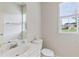 Bright bathroom with a white vanity, mirror and modern fixtures at 8970 Ruel Ln, Suwanee, GA 30024