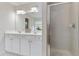 A bathroom featuring dual sinks, vanity with cabinet storage and a walk-in shower at 8970 Ruel Ln, Suwanee, GA 30024