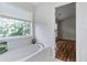 A bright bathroom featuring a soaking tub and a large window with natural light at 8970 Ruel Ln, Suwanee, GA 30024
