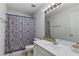 Bathroom featuring a shower, toilet, vanity with sink, and decorative shower curtain at 8970 Ruel Ln, Suwanee, GA 30024