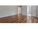 An empty bedroom featuring hard wood floors and access to closet and bathroom at 8970 Ruel Ln, Suwanee, GA 30024