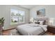 A serene bedroom with large window and comfortable bed at 8970 Ruel Ln, Suwanee, GA 30024