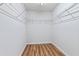 A walk-in closet with wooden floors and built-in metal shelving at 8970 Ruel Ln, Suwanee, GA 30024