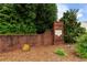 Well-maintained community sign surrounded by mature trees and lush landscaping at 8970 Ruel Ln, Suwanee, GA 30024