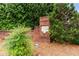 Brick community sign surrounded by lush greenery and well-maintained landscaping at 8970 Ruel Ln, Suwanee, GA 30024
