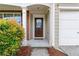 Welcoming front entrance with a cozy porch, brick accents, and neat landscaping at 8970 Ruel Ln, Suwanee, GA 30024