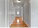 Clean hallway with light walls, hardwood floors, and multiple doorways at 8970 Ruel Ln, Suwanee, GA 30024