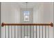 Second story hallway with a window and a view looking down the staircase at 8970 Ruel Ln, Suwanee, GA 30024