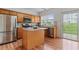 Updated kitchen featuring stainless steel appliances, a center island, and sliding glass door to yard at 8970 Ruel Ln, Suwanee, GA 30024
