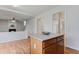 Open floor plan with kitchen island, hardwood floors and view to living room fireplace at 8970 Ruel Ln, Suwanee, GA 30024