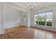 Bright living room with large windows, fresh paint, and beautiful hardwood floors at 8970 Ruel Ln, Suwanee, GA 30024