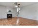 Cozy living room with wood flooring, fireplace, and staircase leading to the second floor at 8970 Ruel Ln, Suwanee, GA 30024