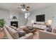 Comfortable living room with fireplace, contemporary furniture, and a staircase at 8970 Ruel Ln, Suwanee, GA 30024