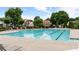 Large community pool surrounded by lounge chairs and well-maintained landscaping at 8970 Ruel Ln, Suwanee, GA 30024