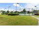 Beautifully maintained community tennis court surrounded by green space and mature trees at 8970 Ruel Ln, Suwanee, GA 30024