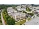 Luxury townhome community with lush landscaping and convenient access to retail and commercial spaces in the background at 132 Grand Cres, Alpharetta, GA 30009