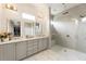 Bathroom features double sink vanity, a glass enclosed shower with dual shower heads, and marble flooring at 132 Grand Cres, Alpharetta, GA 30009