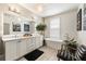 Bright bathroom with soaking tub, double vanity, modern lighting, and chic decor at 132 Grand Cres, Alpharetta, GA 30009