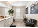 Modern bathroom featuring a soaking tub, white vanity with double sinks, and stylish decor at 132 Grand Cres, Alpharetta, GA 30009
