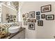 Stylish bathroom featuring patterned wallpaper, floating sink, and decorative Gathering photos at 132 Grand Cres, Alpharetta, GA 30009