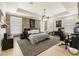 Spacious bedroom with brick accent wall, modern lighting, and home office setup at 132 Grand Cres, Alpharetta, GA 30009