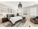 Cozy bedroom with a plush bed, side tables with lamps, and natural light from shuttered windows at 132 Grand Cres, Alpharetta, GA 30009