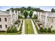 Beautiful courtyard view of luxury townhomes featuring lush landscaping and outdoor seating areas at 132 Grand Cres, Alpharetta, GA 30009