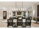 Elegant dining area with a modern chandelier, adjacent to a spacious living room at 132 Grand Cres, Alpharetta, GA 30009