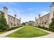 Exterior showcasing the manicured green space between townhomes, offering a serene and inviting community atmosphere at 132 Grand Cres, Alpharetta, GA 30009