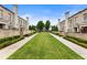 Exterior showcasing the manicured green space between townhomes, offering a serene and inviting community atmosphere at 132 Grand Cres, Alpharetta, GA 30009
