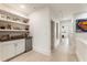 Well-lit upstairs hallway with built-in shelves, beverage center, and modern decor at 132 Grand Cres, Alpharetta, GA 30009