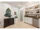 Upstairs hallway featuring a beverage center with shelves, cabinets, and a small fridge at 132 Grand Cres, Alpharetta, GA 30009