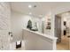 Bright upstairs hallway with textured wall, artwork, and views into other rooms at 132 Grand Cres, Alpharetta, GA 30009