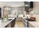 An open kitchen features an island with a sink and stainless steel appliances at 132 Grand Cres, Alpharetta, GA 30009