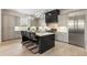 An open kitchen features an island, stainless steel appliances, and modern lighting at 132 Grand Cres, Alpharetta, GA 30009