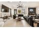 Bright living area with a fireplace, large sectional sofa, and modern lighting at 132 Grand Cres, Alpharetta, GA 30009