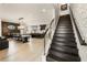 Open-concept living space with staircase, dining area, kitchen, and light hardwood floors at 132 Grand Cres, Alpharetta, GA 30009