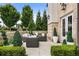 Outdoor patio featuring lounge furniture, lush greenery, and a manicured landscape at 132 Grand Cres, Alpharetta, GA 30009