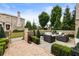 Inviting outdoor patio featuring comfortable seating, manicured hedges, and brick walkway at 132 Grand Cres, Alpharetta, GA 30009