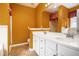 Bathroom featuring a double vanity with white cabinets and a tile shower at 4200 Vinca Way, Union City, GA 30291