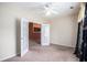 Bedroom with neutral carpet, a ceiling fan, and a view into the kitchen through french doors at 4200 Vinca Way, Union City, GA 30291