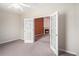 Bedroom with neutral carpet, a ceiling fan, and a view into the living room through french doors at 4200 Vinca Way, Union City, GA 30291