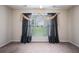 Bright bedroom features carpeted floors and a large window with decorative drapes at 4200 Vinca Way, Union City, GA 30291