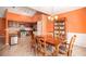 Open floor plan showcasing a dining area next to a kitchen with stainless steel appliances and dark wood cabinets at 4200 Vinca Way, Union City, GA 30291