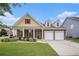 Charming two-story home features a two-car garage, manicured lawn, and beautiful landscaping at 4200 Vinca Way, Union City, GA 30291