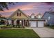 Charming two-story home features a two-car garage, manicured lawn, and beautiful landscaping at 4200 Vinca Way, Union City, GA 30291