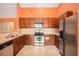 Well-equipped kitchen with stainless steel appliances, wood cabinets, and ample counter space for cooking at 4200 Vinca Way, Union City, GA 30291