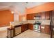 Kitchen with tiled floor, stainless steel dishwasher, and pass-through to living area at 4200 Vinca Way, Union City, GA 30291