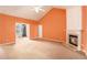 Bright living room featuring a fireplace, carpet flooring, and open access to other rooms at 4200 Vinca Way, Union City, GA 30291