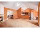 Spacious living room featuring a fireplace, ceiling fan and a view of kitchen appliances at 4200 Vinca Way, Union City, GA 30291